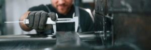 A close up of a worker using a tool for precision steel stamping