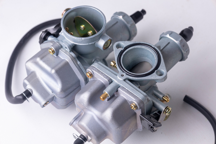 A closeup of a carburetor, an example of small engine components